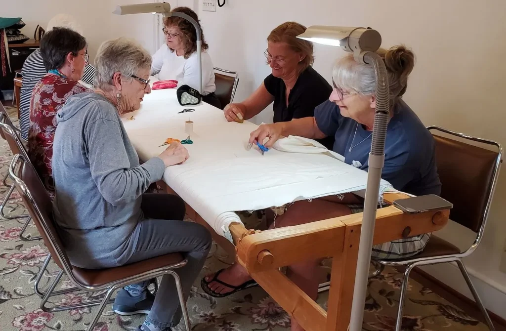 women quilting in a group
