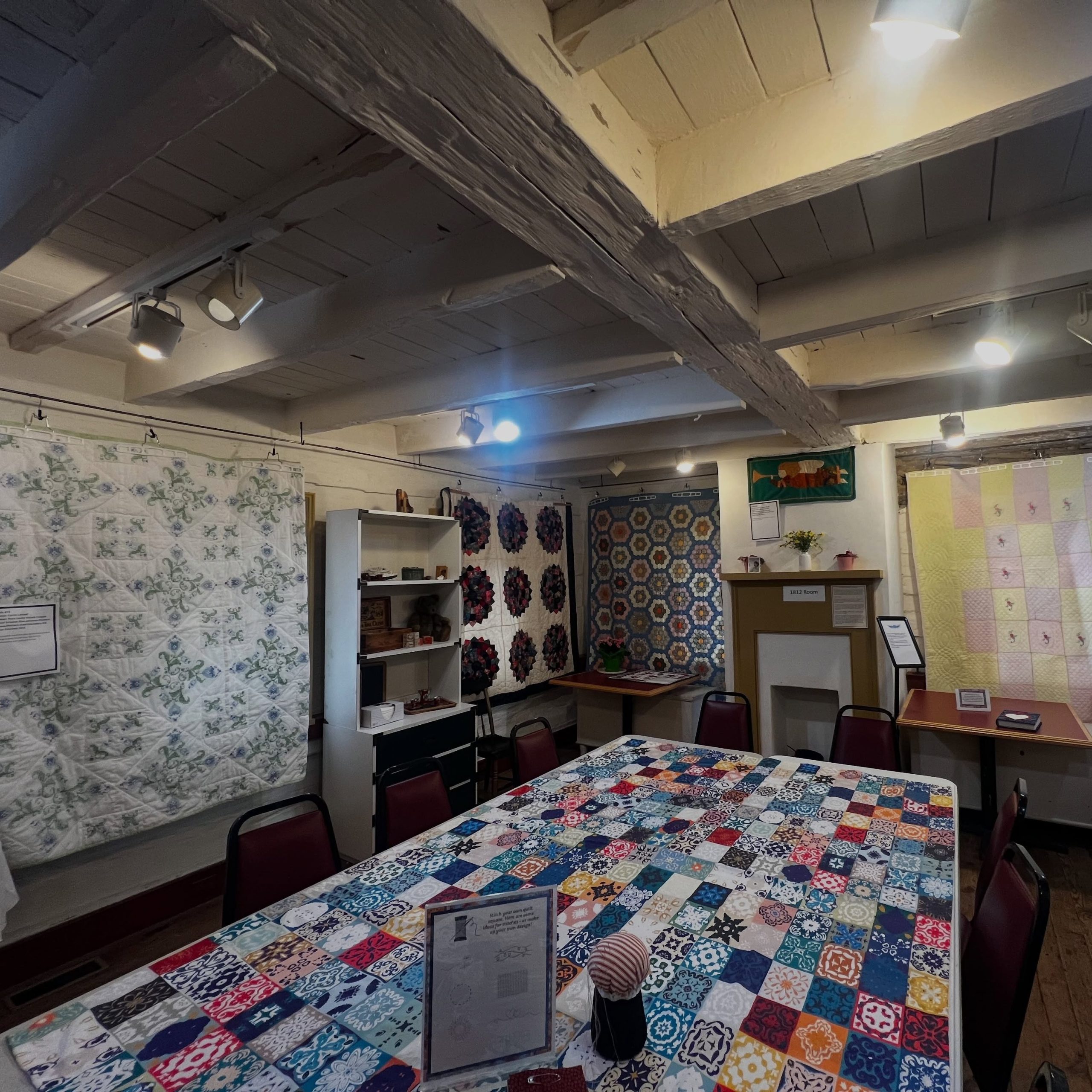 quilts on display inside cottage house
